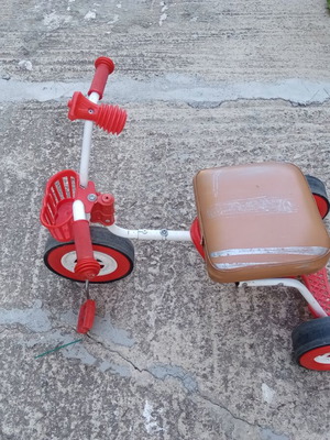 Red children's tricycle with extra foam seat