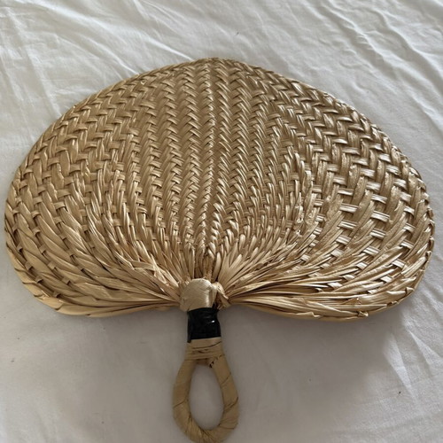 Handmade fans used, natural materials palm leaves and rattan