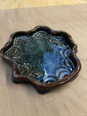 Handmade decorative and functional plate with blue, green, and brown waves