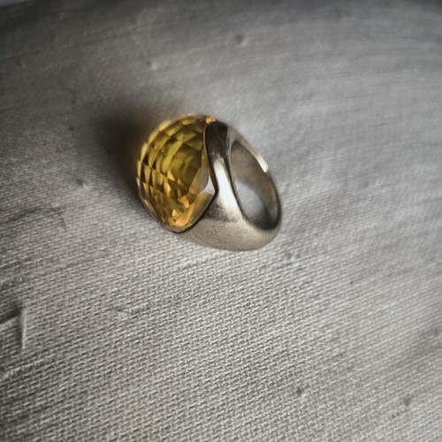 Statement ring with thick honey-colored glass on gold metal, used
