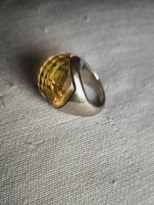 Statement ring with thick honey-colored glass on gold metal, used