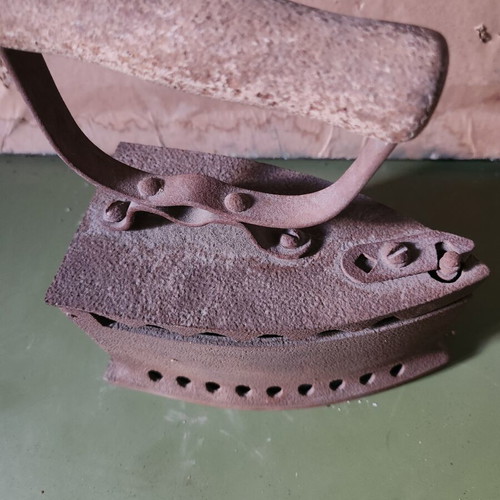 Charcoal iron used, traditional cast iron with wooden handle