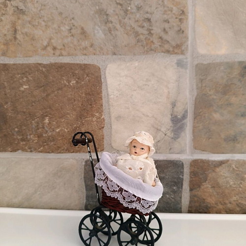Porcelain doll baby in stroller used