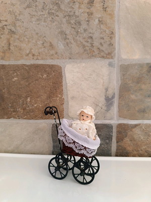 Porcelain doll baby in stroller used