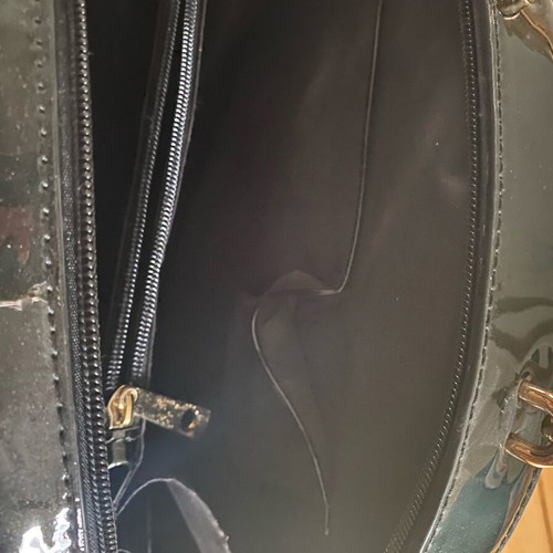 Round black glossy handbag like new with gold handles