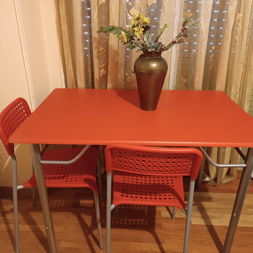 Dining table with inox legs and 4 chairs in red, like new