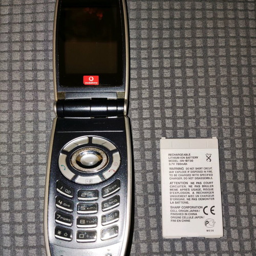 Sharp GX25 used black mobile phone with wear marks