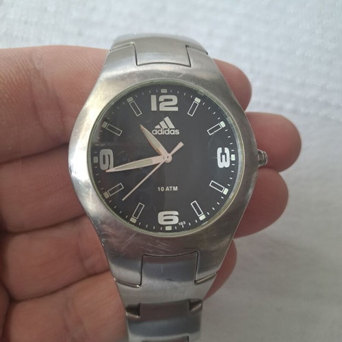 Adidas watch used with black and silver bracelet