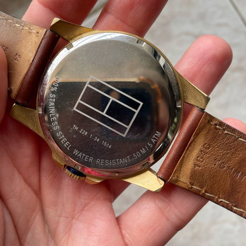 Tommy Hilfiger watch used with brown leather strap and gold dial