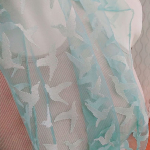 Lightweight scarf used, semi-transparent green with white hummingbirds