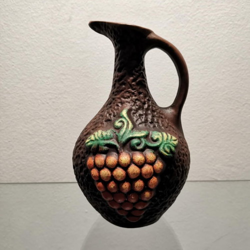 Clay jug used with embossed designs and grape cluster