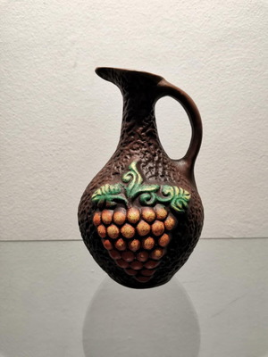 Clay jug used with embossed designs and grape cluster