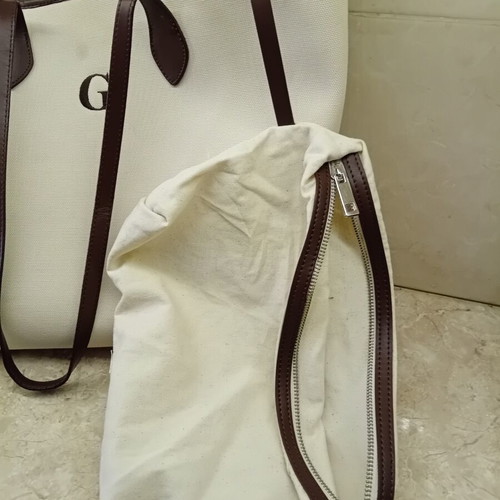 Large beige fabric shoulder bag with brown leather details