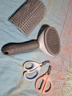 Pet grooming set like new with nail clippers, comb, and fur scraper