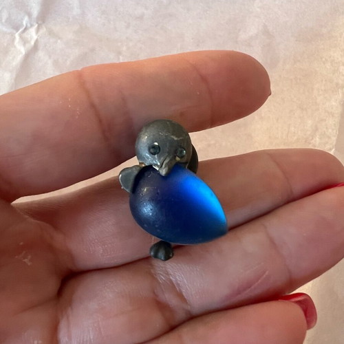 Silver penguin pin used with blue stone
