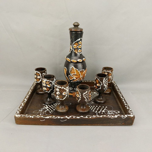 Vintage carved painted wooden bottle with 6 glasses on wooden tray used