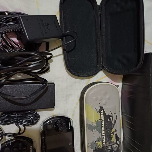 Sony PSP handheld consoles with accessories and games