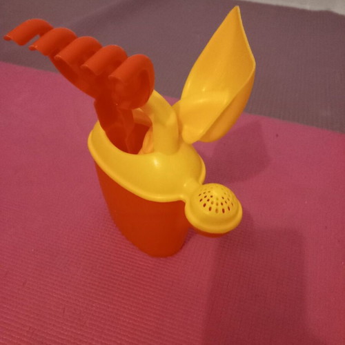 Children's beach watering can set used with shovel and rake