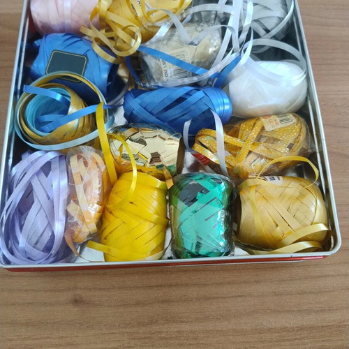 Metal box with various gift ribbons like new