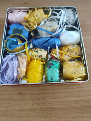 Metal box with various gift ribbons like new