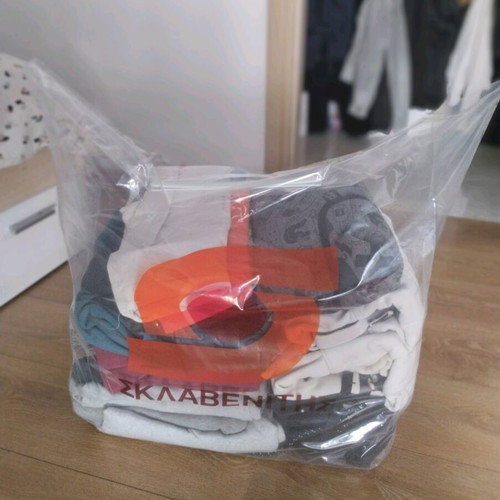 a bag full of men's branded clothes aged 10 to 13-14