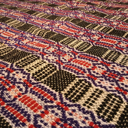 Vintage woolen blanket with red, purple, white and dark green patterns