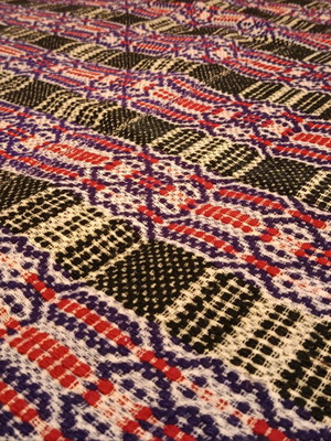 Vintage woolen blanket with red, purple, white and dark green patterns