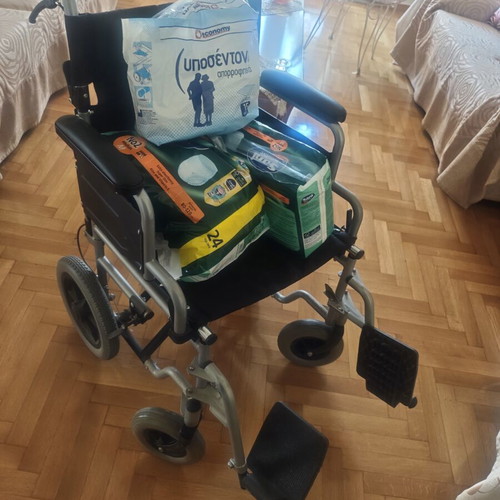 Folding wheelchair with handbrake and footbrake