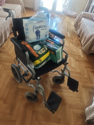 Folding wheelchair with handbrake and footbrake