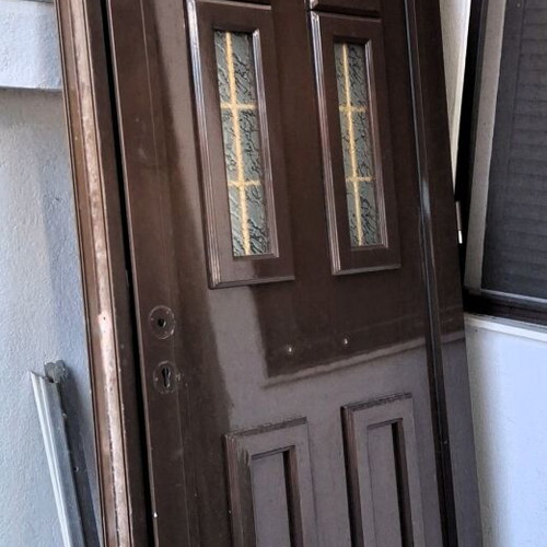 Two brown aluminum entrance doors with frames, handles and locks