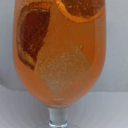 Handmade candle in Aperol Spritz glass with Aperol Spritz scent