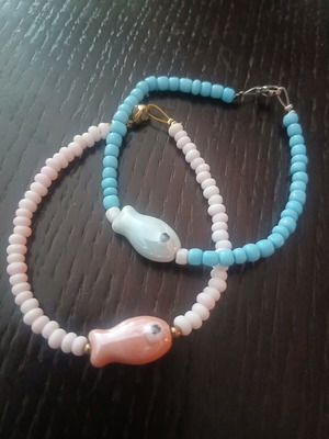 Two handmade island-style bracelets with beads and stone fish