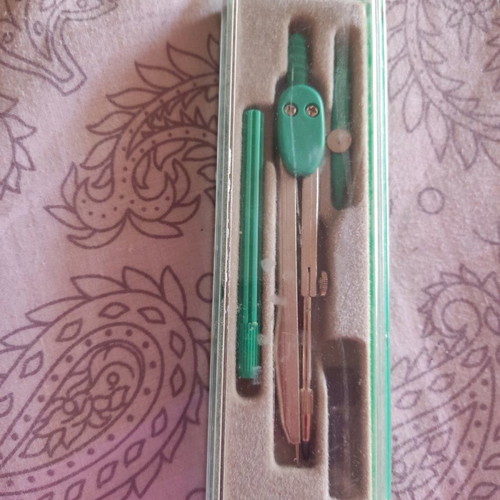 School compass used with pencil tip and extra replacement