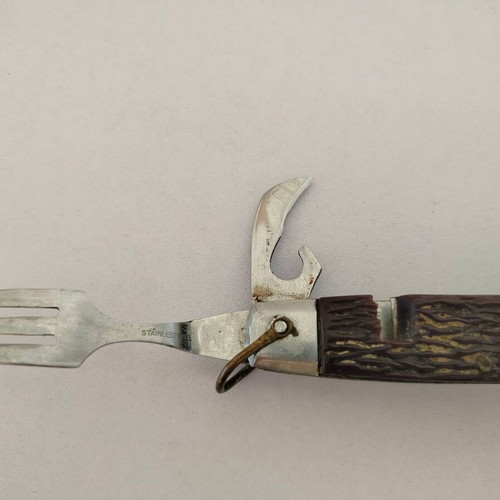 Vintage pocket knife with integrated fork and spoon, used