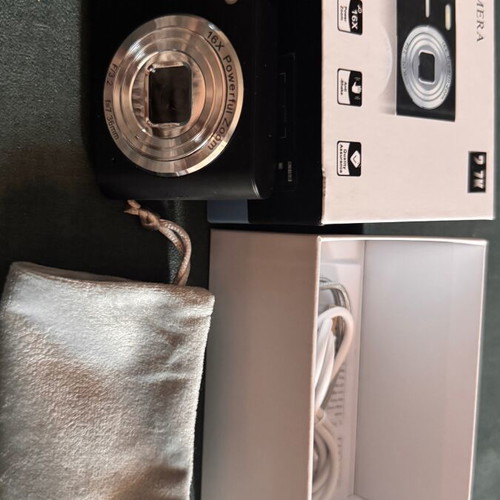 Digital camera used with velvet case, cable, battery, and strap
