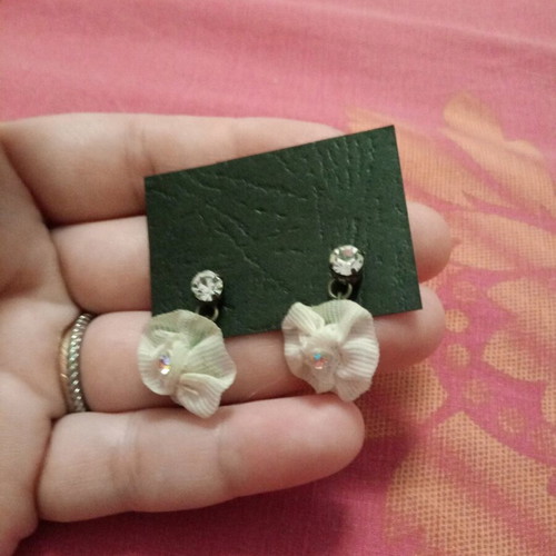 Fwo earrings with white fabric flowers and rhinestones hanging, unworn
