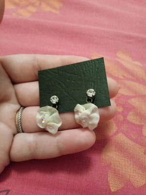 Fwo earrings with white fabric flowers and rhinestones hanging, unworn