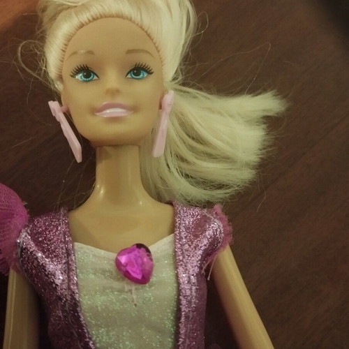 Doll with pink earrings and articulated joints used