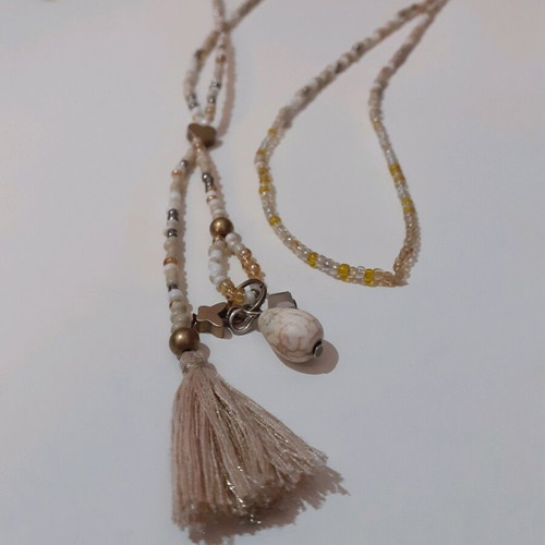 Long beaded necklace new in white and gold shades with tassel