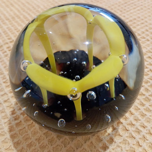 Vintage glass paperweight with yellow dome design