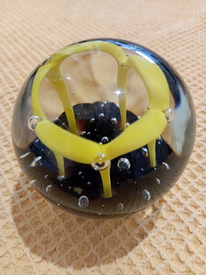 Vintage glass paperweight with yellow dome design