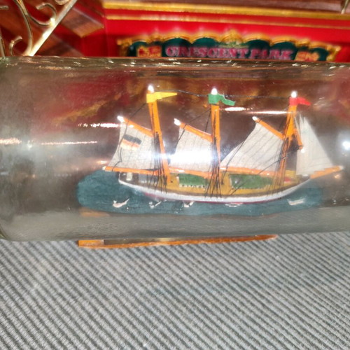 Ship in a bottle used with sealed top and wooden base