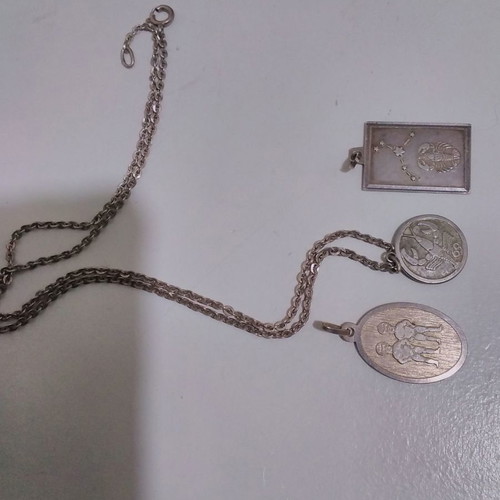 Silver pendant necklace used with zodiac and catholic figures
