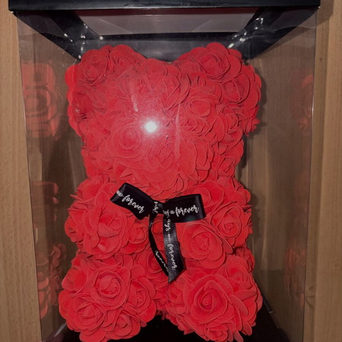 Handmade teddy bear made of red artificial roses