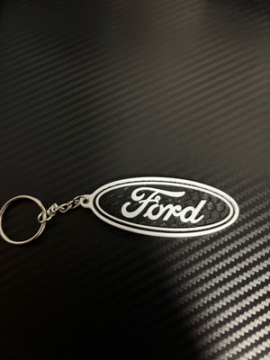 Ford keychain like new, plastic, black and white