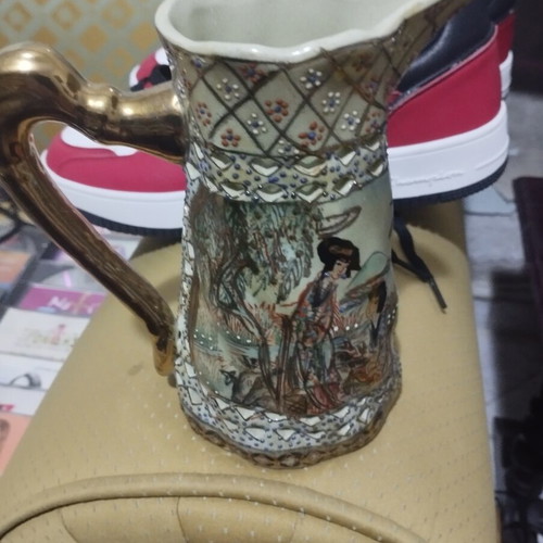Collectible ceramic pitcher with embossed decorations, new