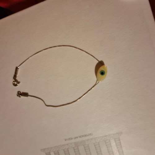 Thin bracelet with metal chain and eye centerpiece like new