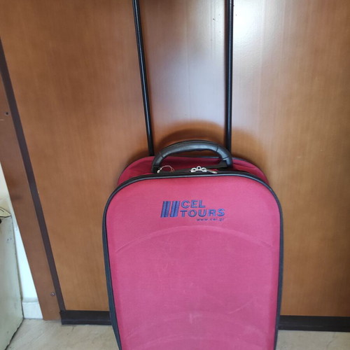 Red fabric travel suitcase trolley carry-on