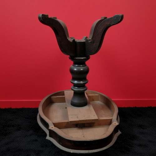 Round wooden table used with ornate base