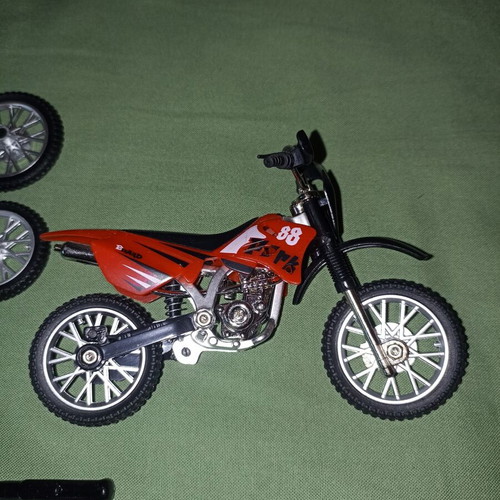 Motocross toy miniature new with extra wheels and nuts